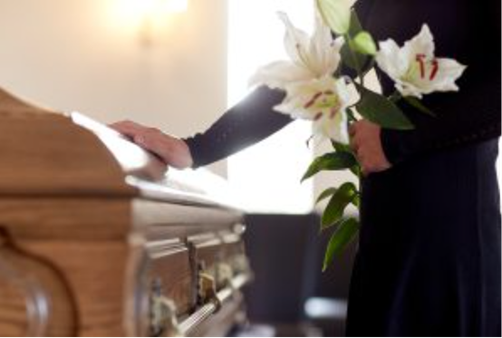 Guy placing hand on casket and contemplates probate administration